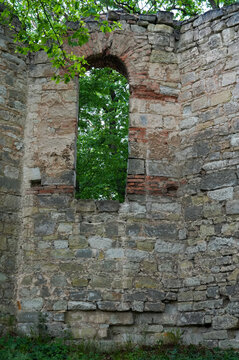 Old stone wall with window and green trees in the background, Czech Republic