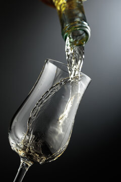 Whiskey is poured from a bottle into a glass.
