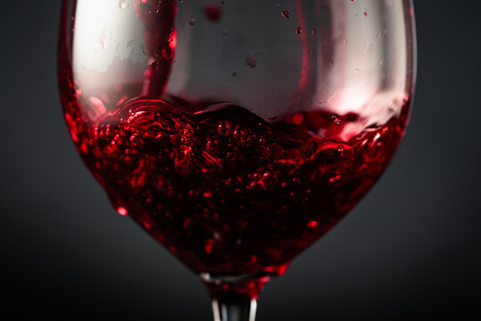 Red wine of rich dark color being poured into a glass.