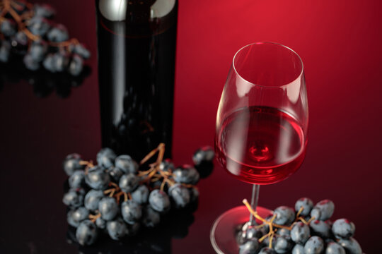 Red wine and juicy blue grapes.