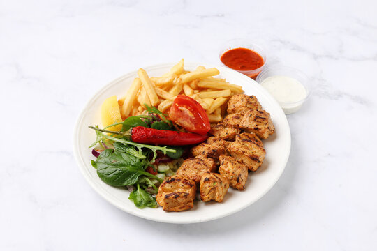 Tavuk Sis - Grilled Chicken Kebab with French Fries, Fresh Salad, Tomato and Garlic Sauce
