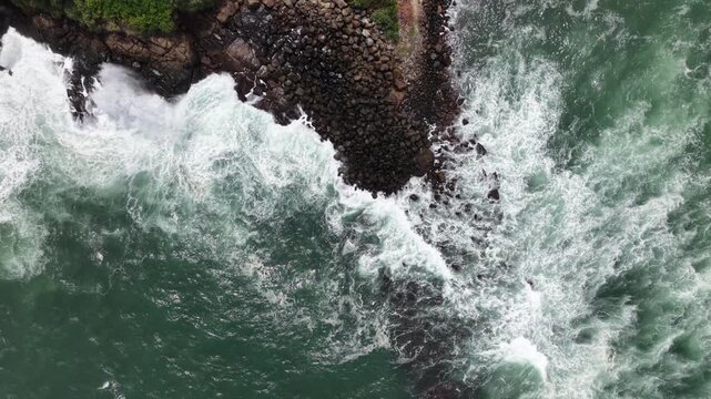 Drone Photography of White Sea Foam Crashing on Coastal Rocks