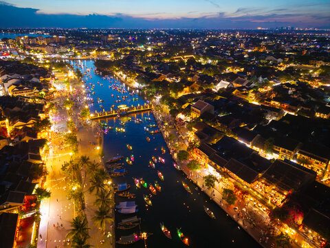 Panorama aerial drone view of Hoi An ancient town with boat tour and beautiful lanterns in sunset. UNESCO world heritage. One of the most travel popular touristic destinations
