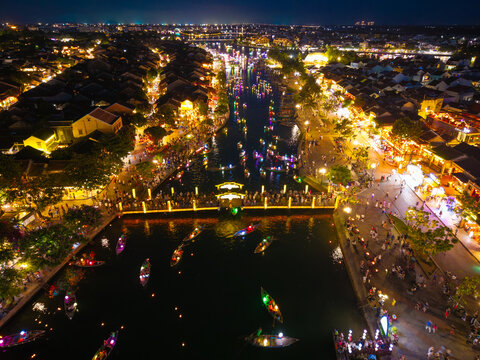 Panorama aerial drone view of Hoi An ancient town with boat tour and beautiful lanterns in night. UNESCO world heritage. One of the most travel popular touristic destinations
