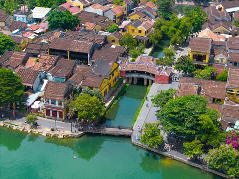 Aerial view of Chua Cau or Japanese Covered ancient Bridge and River in Old city of Hoi An, Vietnam. One of the most travel popular touristic destinations, UNESCO world heritage 
