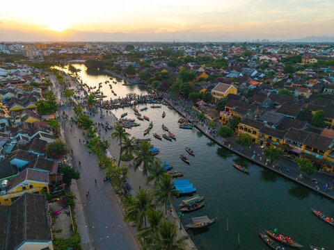 Panorama aerial drone view of Hoi An ancient town with boat tour and beautiful lanterns in sunset. UNESCO world heritage. One of the most travel popular touristic destinations

