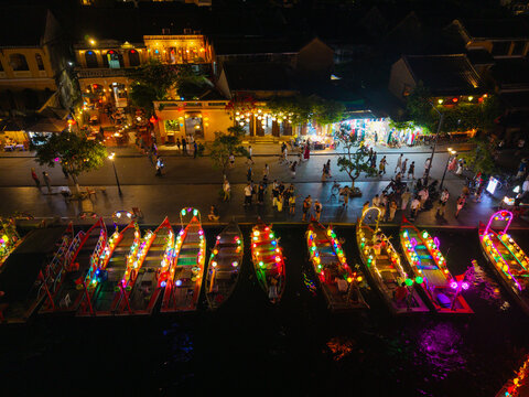 Panorama aerial drone view of Hoi An ancient town with boat tour and beautiful lanterns in night. UNESCO world heritage. One of the most travel popular touristic destinations