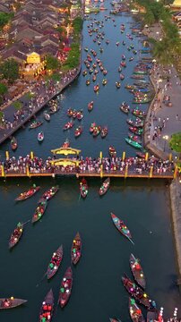 Timelapse or time-lapse of Aerial view of Hoi An old town or Hoian ancient town in evening. Royalty high-quality free stock of Hoai river and boat tour night traffic. One of the most popular touristic