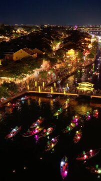 Timelapse or time-lapse of panorama aerial view of Hoi an ancient town in evening. Royalty high-quality stock of Hoai river and boat tour night traffic. One of the most popular touristic destination
