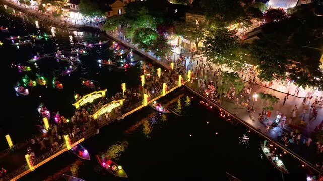 Timelapse or time-lapse of panorama aerial view of Hoi an ancient town in evening. Royalty high-quality stock of Hoai river and boat tour night traffic. One of the most popular touristic destination