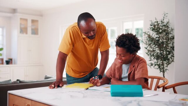 Father, son and help in house with homework, learning math and conversation for child development. Black man, kid and discussion in home with notebook, writing and teaching knowledge for education.
