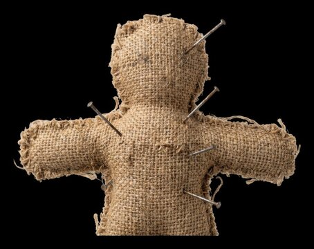 Burlap voodoo doll representing targeted system vulnerability being pierced by metal pins, cybersecurity threat, risk management, strawman modern technology business concept