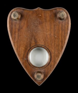 Vintage wooden planchette resting on  to facilitate mystical communication via a spirit board session, occult investigation modern technology business concept