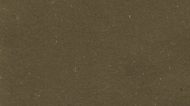 Brown recycled paper texture surface background motion video clip showing fine grain and fiber details