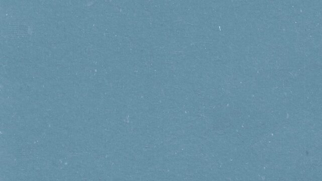 Solid blue paper texture background with vintage film grain effect for professional digital motion video footage