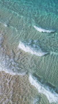 Top View of Clear Ocean Water Over Sandy Beach