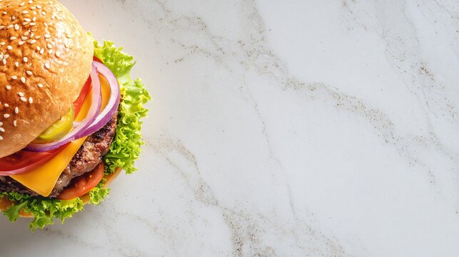 A top-down flat lay of a gourmet burger placed along the bottom edge of a light marble surface, leaving wide clean copy space above under soft daylight