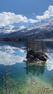 Spectacular Engadin Valley mountain landscape with snow-capped peaks reflecting in calm Silsersee lake, Engadin, Graub&uuml;nden, Switzerland