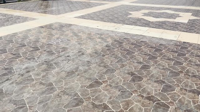 Close up of interlocking polygonal stone tiles on urban sidewalk walkway