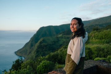 Young woman smiling enjoying coastal mountain view at dusk © Alberto