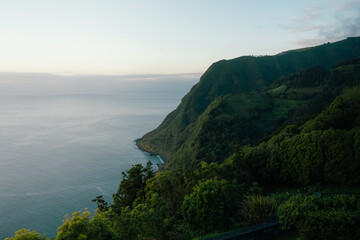 Sao miguel coastline at dusk with lush green mountains © Alberto