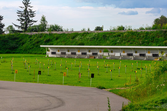 Outdoor Shooting Range With Numbered Targets On Grassy Field