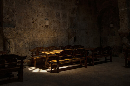 A dining table and benches in the refectory under the vaults of the Haghartsin Monastery, Armenia