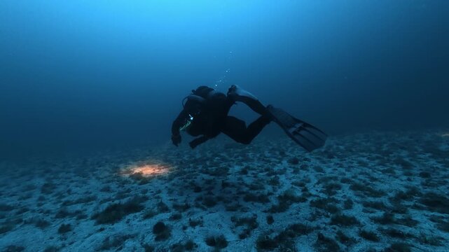 Scuba diver in a deep underwater scene