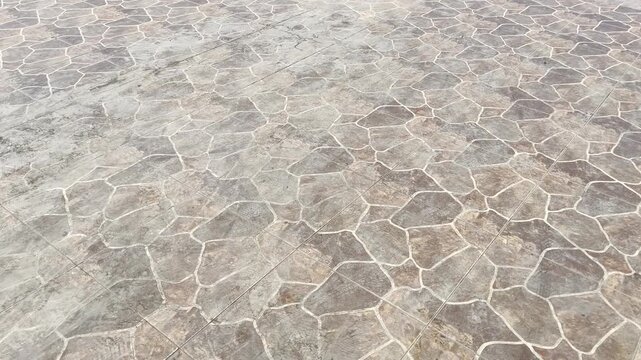 Reddish brown stone pavement pattern on outdoor walkway