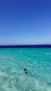 Aerial View of Person Swimming in Clear Tropical Water