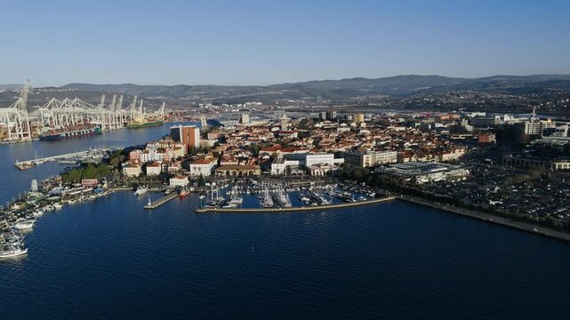 The view shows Koper, Slovenia with its marina, city buildings, and waterfront along the Adriatic Sea during daylight.
