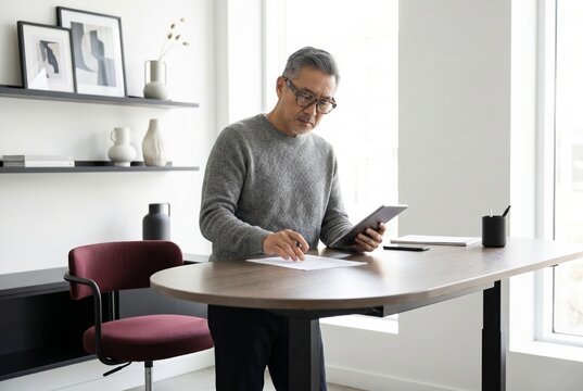 Confident senior man working as a creative consultant in a bright contemporary office