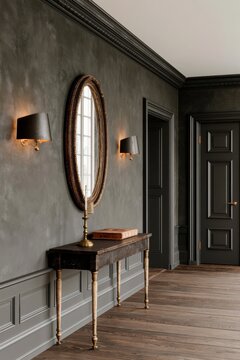 Dark academia hallway featuring deep forest green walls, elegant wall sconces, a round mirror, and a wooden console table with decorative items