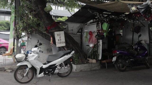 Residential apartment building in Din Daeng district, Bangkok, Thailand. Urban daytime apartment. With motorcycle