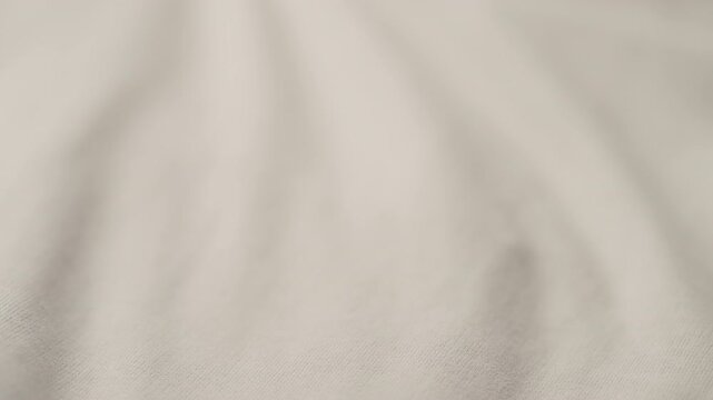 man manually check ivory color cotton fabric for clothing with hands