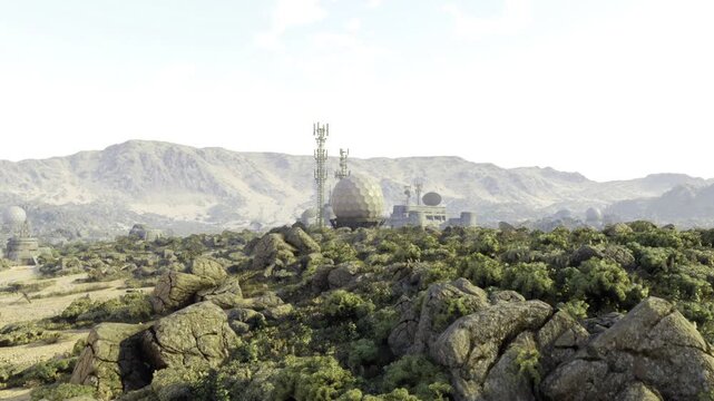 Operational communications hub atop rocky hill, active antennas and relay arrays with maintenance access roads, clear midday sky and functional industrial