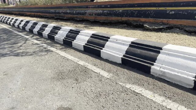 Close up of urban road barrier pavement with striped pattern