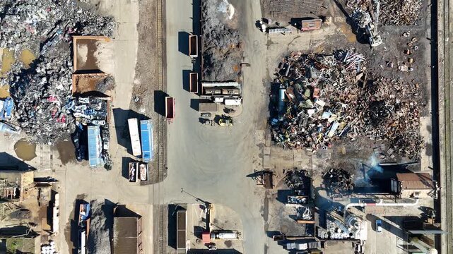 Top down aerial over sprawling metal scrapyard