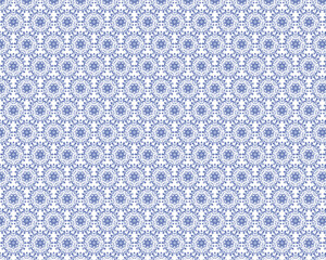 Fototapeta premium This image features a seamless decorative pattern in shades of indigo blue on a white background. It comprises repeating floral and vine motifs in a symmetrical arrangement, creating a luxurious and c