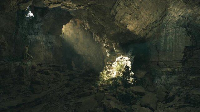 Sunlit cavern in Mammoth Cave system, rugged limestone walls, scattered boulders, mossy patches, beam of light piercing chamber, cool moist atmosphere, sense
