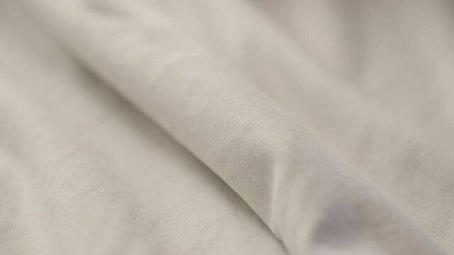 man manually check gray blue color cotton fabric for clothing with hands