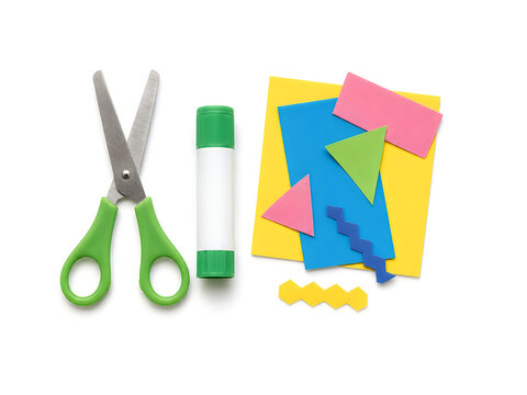 School scissors and glue stick. Craft supplies with colorful paper shapes. Creative art project kit.