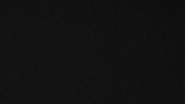 Texture of velvet black paper. Surface of black rough paper, slowly rotating.
Abstract stop-motion video of dark black felt or wool fabric texture. Scratches and dust dark grunge paper background.