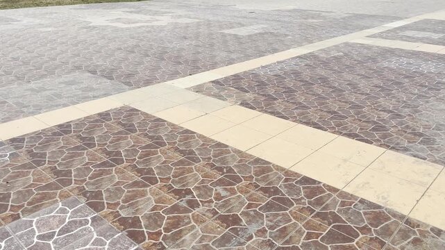 Stone pavement pattern on public sidewalk during golden hour