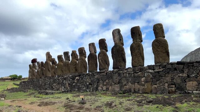 Daytime view of Ahu Tongariki on Easter Island, Chile. Fifteen iconic Moai statues standing against a bright blue sky and the Pacific Ocean. Famous archaeological site and UNESCO World Heritage 