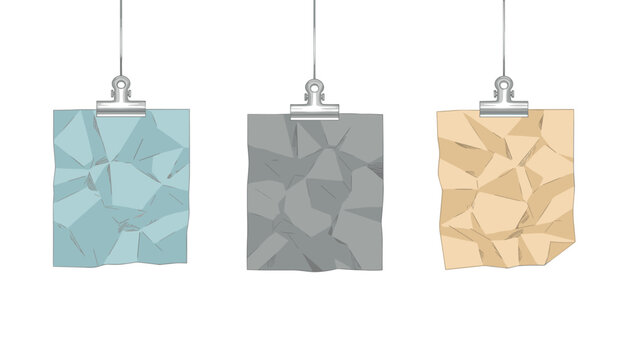 Three crumpled sheets of paper in blue, grey, and brown hanging on metal binder clips against white background.