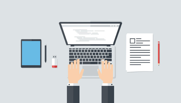 Top down overhead view of a programmer typing on a laptop next to a digital tablet and job resume on a desk.