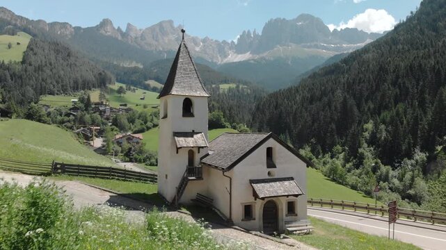Dolomites mountain scenery with the church of Tiers am Rosengarten, South Tyrol, Italy