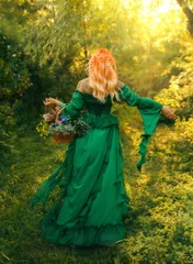 Happy fantasy woman healer. herbalist hand holding basket with herbs for tea flowers essential oil, elf redhead girl walking in sun rays magic light forest green grass trees. fairy dress back view © kharchenkoirina