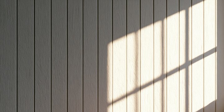 Sunlight casts geometric shadows on a textured vertical wood paneled wall